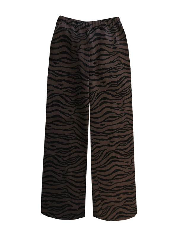 ATHENS - Tiger. These are a pair of high-waisted trousers featuring a comfortable thick elastic waistband for easy everyday wear. The loose fit provides comfortability and easy wear, skimming the natural shape of the body with a slightly cropped leg. 