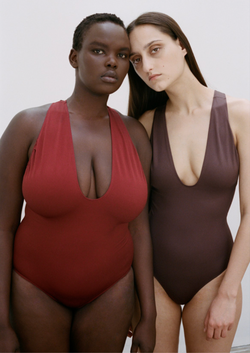 Two women wearing PRISM swimsuits