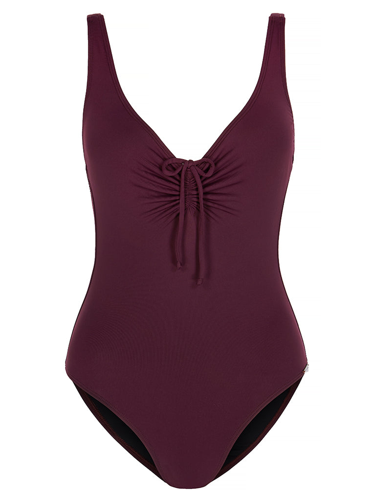 SHELTER ISLAND - Wine. This is a simple yet sexy one-piece swimsuit. With a high cut leg, scoop neckline featuring adjustable gathered detail with tie and thin shoulder straps. The back of the body scoops low with gathered detail with tie and the centre back to match the front. This lightweight, matte swim fabric is fully lined.