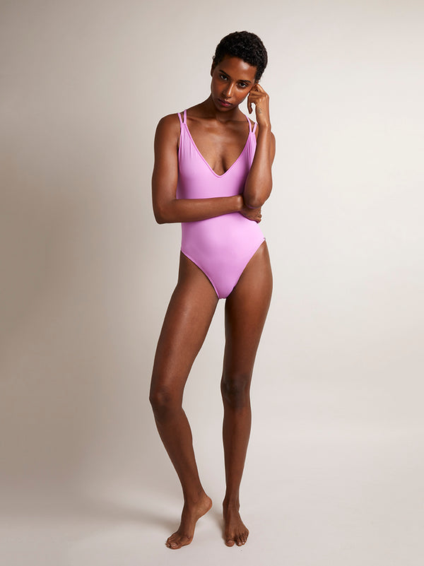 MYKONOS - Magenta. Swimsuit features a plunge neckline and double straps , cross over the back, high cut leg and slight yet flattering bottom coverage.