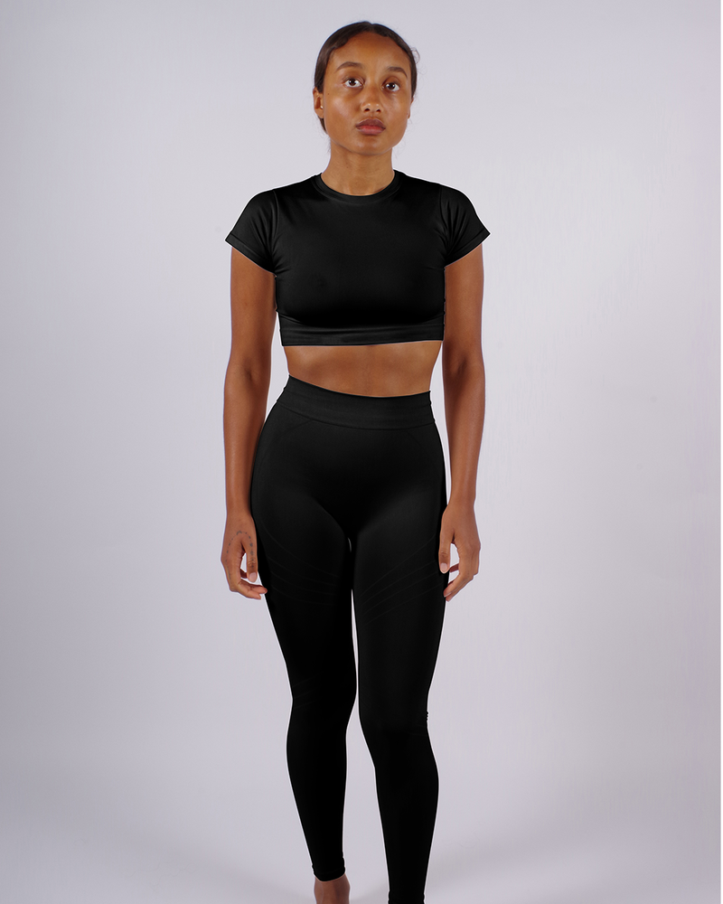 model wearing lucid leggings in black front - sustainable gym leggings - compression leggings - shaping leggings - plus size gym leggings - flattering leggings - leggings for exercise - leggings for yoga