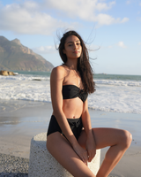 PUERTO VIEJO - Ebony. This feminine bandeau-style bikini top has soft gathered cups making it ideal for small and medium bust. The U-shaped gunmetal bar at the front holds the top firmly in place. This style does not come with strap and has a gunmetal hook and fabric fastening the centre back
