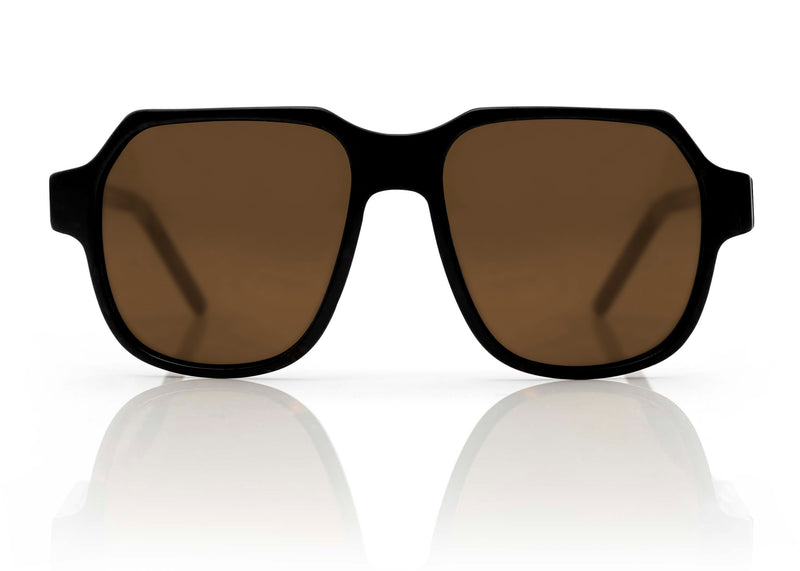 DAKOTA - Black with Brown Lens. A modern interpretation of the retro aviator frame. Reimagined into a lightweight, small to medium sized style, suitable for smaller faces shapes with its compact dimensions. Carl Zeiss CR39 brown lenses with an anti-scratch coating 100% UVA/UVB protection. 